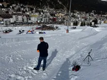 Setting up photocells on a snowy course above a ski resort