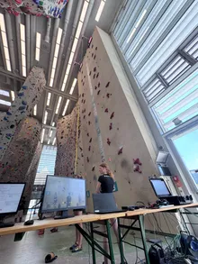 Timing screens at the base of a speed climbing wall