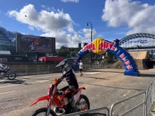A motocross rider at the Red Bull finish arch beside the Tyne Bridge in Newcastle