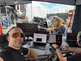 Tobias Däuber with a headset at the STIHL Timbersports graphics desk