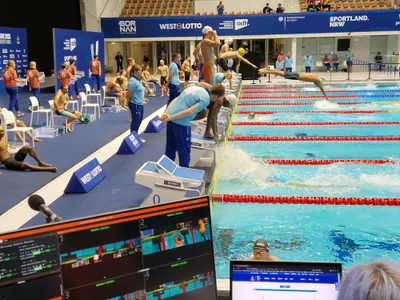 TimestampedVideoSystem on a poolside screen during a swimming start