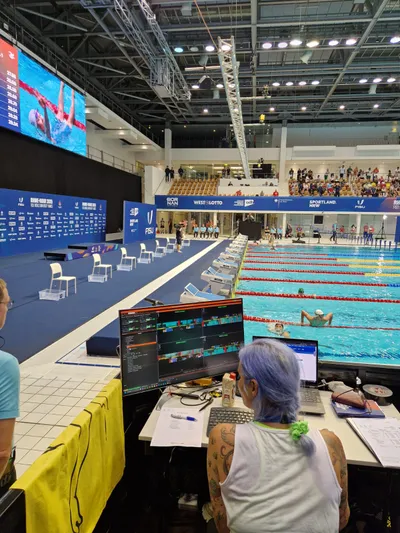 A judge reviewing swimming camera feeds with TimestampedVideoSystem at the pool deck